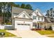 Lovely two-story home with a two-car garage, manicured lawn, and tasteful landscaping at 2075 Toad Hollow Trl, Apex, NC 27502