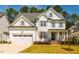 Beautiful two-story home featuring a two-car garage, well-manicured lawn and landscaping at 2075 Toad Hollow Trl, Apex, NC 27502