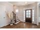 Bright foyer with hardwood floors, decorative vase, and staircase leading to the upper level at 2075 Toad Hollow Trl, Apex, NC 27502