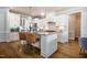 Modern kitchen boasts white cabinets, stainless appliances, and a central island with seating at 2075 Toad Hollow Trl, Apex, NC 27502