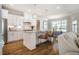 Bright kitchen with stainless appliances, white cabinets, granite countertops, and island seating at 2075 Toad Hollow Trl, Apex, NC 27502
