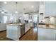 Open-concept kitchen features stainless appliances, granite counters, and views to dining and living spaces at 2075 Toad Hollow Trl, Apex, NC 27502