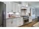 Modern kitchen featuring stainless steel appliances, granite countertops, and white cabinets at 2075 Toad Hollow Trl, Apex, NC 27502