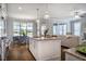 Kitchen island with granite countertops offers seating and views to a dining area and living room at 2075 Toad Hollow Trl, Apex, NC 27502