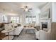 Comfortable living room with fireplace, large windows, and ceiling fan provides relaxing space at 2075 Toad Hollow Trl, Apex, NC 27502