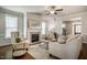 Bright living room featuring hardwood floors, a fireplace, and plenty of natural light at 2075 Toad Hollow Trl, Apex, NC 27502