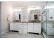 Bright bathroom with white cabinets, granite countertops, double sinks and a tiled glass enclosed shower at 2075 Toad Hollow Trl, Apex, NC 27502