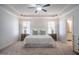 Spacious main bedroom featuring a king-size bed, two nightstands, and ensuite bathroom access at 2075 Toad Hollow Trl, Apex, NC 27502