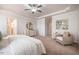 Open main bedroom with white dresser and sitting area, with a view to the main bath at 2075 Toad Hollow Trl, Apex, NC 27502
