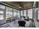Relaxing screened porch with an outdoor ceiling fan, comfortable seating and backyard views at 2075 Toad Hollow Trl, Apex, NC 27502