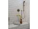 Close-up of a shower with gray accents, a rain shower head and decorative plant against white subway tile at 2075 Toad Hollow Trl, Apex, NC 27502
