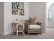 Comfortable sitting area featuring a patterned armchair, side table with flowers and modern art at 2075 Toad Hollow Trl, Apex, NC 27502