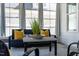 Comfortable seating area in a sunroom featuring lots of natural light and yellow pillows at 2075 Toad Hollow Trl, Apex, NC 27502