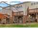 Townhome backyard with wooden decks, brick foundation, and grass at 208 Chandler Chase Ct, Morrisville, NC 27560
