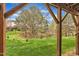 Scenic backyard view featuring a lush green lawn, trees, and a house at 208 Chandler Chase Ct, Morrisville, NC 27560