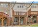 Townhome backyard featuring wooden decks, brick foundation, and grass at 208 Chandler Chase Ct, Morrisville, NC 27560