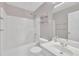 Well-lit bathroom featuring a shower and tub with shelving and updated sink at 208 Chandler Chase Ct, Morrisville, NC 27560