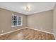 Neutral bedroom features wood-look flooring, trim and ample natural light at 208 Chandler Chase Ct, Morrisville, NC 27560