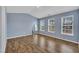 Spacious bedroom with wood floors, light blue walls, and ample natural light at 208 Chandler Chase Ct, Morrisville, NC 27560