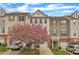 Charming townhome exterior with blooming tree and driveway at 208 Chandler Chase Ct, Morrisville, NC 27560