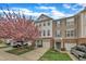 Charming townhomes featuring brick accents, attached garages, and a beautiful flowering tree at 208 Chandler Chase Ct, Morrisville, NC 27560