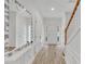 Inviting foyer with wood-look tile, wainscoting, and a decorative mirror at 208 Chandler Chase Ct, Morrisville, NC 27560