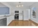 Bright kitchen featuring white cabinets, granite countertops, and stainless steel appliances at 208 Chandler Chase Ct, Morrisville, NC 27560
