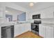 Modern kitchen with white cabinets, granite countertops, and stainless steel appliances at 208 Chandler Chase Ct, Morrisville, NC 27560