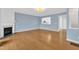 Cozy living room with hardwood floors, fireplace, and a pass-through to the kitchen at 208 Chandler Chase Ct, Morrisville, NC 27560