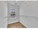 Walk-in closet with built-in metal shelving and laminate wood floors at 208 Chandler Chase Ct, Morrisville, NC 27560