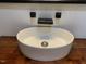 Close-up of a modern, round sink with sleek fixtures and wooden countertop at 208 S Guthrie Ave, Durham, NC 27703