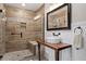 Modern bathroom with a glass shower, rain shower head, and wood vanity at 208 S Guthrie Ave, Durham, NC 27703