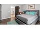 Cozy bedroom featuring hardwood floors, neutral tones, and view to living space at 208 S Guthrie Ave, Durham, NC 27703