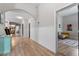 Bright hallway with beautiful wood flooring, neutral walls and inviting decor at 208 S Guthrie Ave, Durham, NC 27703