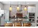 Well-equipped kitchen with stainless steel appliances, stylish island, and brick backsplash at 208 S Guthrie Ave, Durham, NC 27703