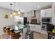 Modern kitchen with an island, stainless steel appliances, and a brick accent wall at 208 S Guthrie Ave, Durham, NC 27703