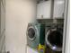Functional laundry room with modern washer and dryer units and overhead cabinets at 208 S Guthrie Ave, Durham, NC 27703
