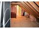 Spacious attic storage with plywood flooring, exposed beams and pink insulation at 218 Keith Hills Rd, Lillington, NC 27546