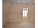 Finished attic space with carpet flooring, dormer window, and neutral paint at 218 Keith Hills Rd, Lillington, NC 27546