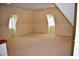 Large finished attic area with carpeting, dormer windows, and ceiling fan at 218 Keith Hills Rd, Lillington, NC 27546