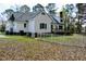 View of the home's backyard with a deck and a white picket fence at 218 Keith Hills Rd, Lillington, NC 27546