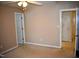 Spacious bedroom with neutral walls, carpeted floor, ceiling fan and features two doorways at 218 Keith Hills Rd, Lillington, NC 27546