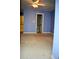 Bedroom featuring blue walls, carpeted floor, ceiling fan and bathroom entrance at 218 Keith Hills Rd, Lillington, NC 27546