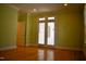 This bedroom features french doors, light green walls, and hardwood flooring at 218 Keith Hills Rd, Lillington, NC 27546