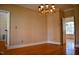 Dining room with hardwood floors, cream walls, white trim, and a doorway view to another room at 218 Keith Hills Rd, Lillington, NC 27546