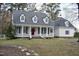 Charming home featuring a classic front porch with stately columns and a vibrant red front door at 218 Keith Hills Rd, Lillington, NC 27546