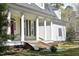 This home features an inviting porch with columns, contrasted by a brick foundation and dark shutters at 218 Keith Hills Rd, Lillington, NC 27546