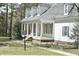 This home features a traditional front porch with stately columns, dark shutters, and a dormer window at 218 Keith Hills Rd, Lillington, NC 27546
