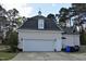 Detached garage with charming details including a weathervane, carriage doors, and an upper window at 218 Keith Hills Rd, Lillington, NC 27546