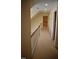 Hallway featuring neutral walls, carpeted floor, and a wooden railing at 218 Keith Hills Rd, Lillington, NC 27546